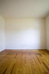 Empty room with wooden floors and white walls