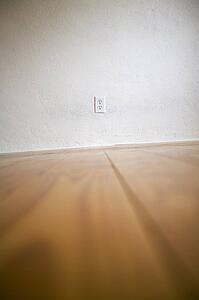 Empty room with wooden floors and white walls
