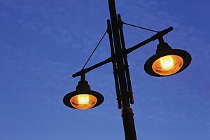 Street lamps against blue sky 