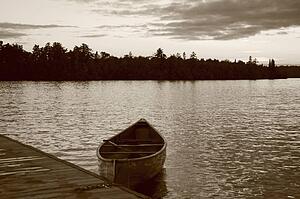 Lake of the Woods, Ontario, Canada; Boat on the water near a dock