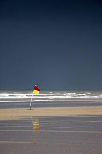 East Riding, Yorkshire, England; Surf warning flag in the wind