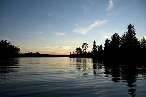 Lake of the Woods, Ontario, Canada; Sunset over placid lake