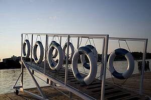 Kenora, Lake of the Woods, Ontario, Canada; Life preservers hanging on a dockside gangway