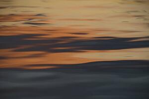 Lake of the Woods, Ontario, Canada; Reflection of sunset in placid water