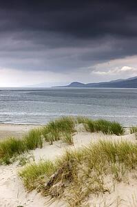 Islay, Scotland; Storm clouds over a beach