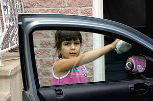 Girl cleaning car window