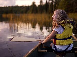 Lake of the Woods, Ontario, Canada; girl in a canoe 