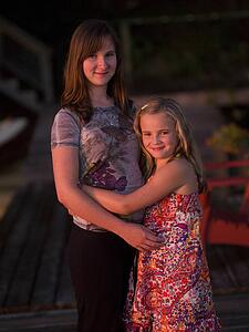 Sisters embracing, Lake of the Woods, Ontario, Canada