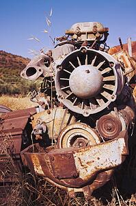 Rusting farm machine abandoned in field