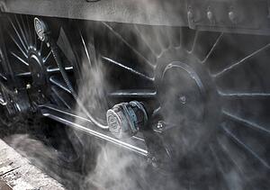 Close-up of steam engine train wheels
