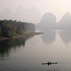 Li River, Yangshuo county, Guilin, Guangxi Province, China; lone boater