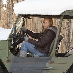 Woman in a snow covered vehicle