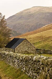 Northumberland, England; Stone house with stone fence