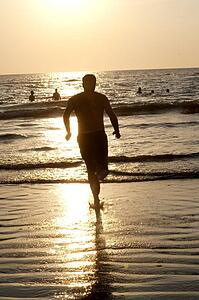 Puerto Vallarta, Mexico; Man running into the water 