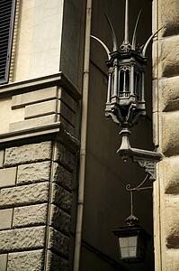 Florence, Italy; Lanterns on building