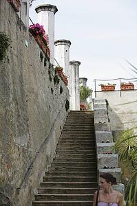 Ravello, Salerno, Campania, Italy; Woman standing at bottom of stairway