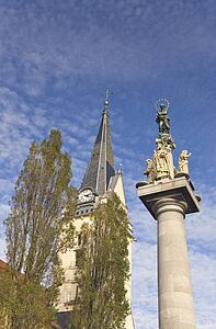 Church of St. James, Ljubljana, Slovenia; St. Mary's column statue and clock tower