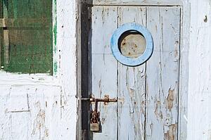 Weathered building; building and door with pealing paint