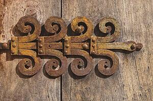Ronda, Malaga Proving, Spain; old decorative hinge on door