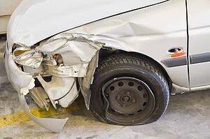 Smashed car; car with smashed front fender and a flat tire