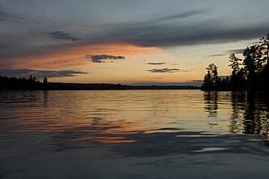 Lake of the Woods, Ontario, Canada; Reflection of majestic sunset in placid lake
