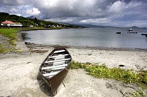 Islay, Scotland; An abandoned canoe by a beach