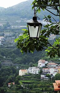 Ravello, Italy; Lantern hanging with countryside behind