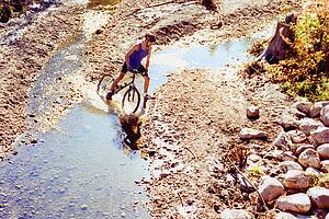 Trail rider crossing creek