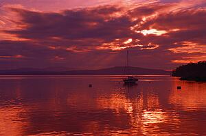 Sailboat at anchor with cloudy evening