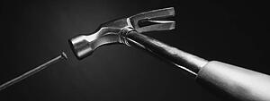 Hammer hitting the nail (black and white)