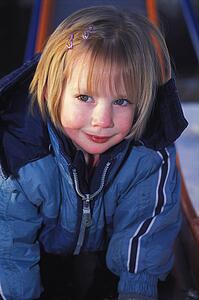 Grinning girl on slide