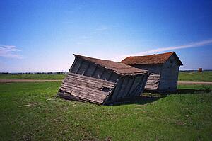Run down shacks in farmer's field