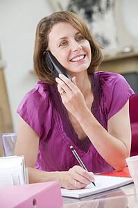 Woman at her desk talking on phone