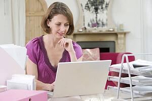 Woman sitting at her desk using laptop