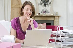 Woman sitting at her desk using laptop