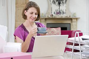 Woman drinking coffee at her desk