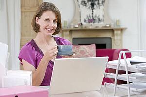 Woman drinking coffee at her desk
