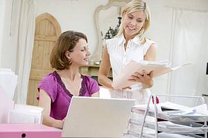 Women looking at paperwork together