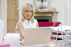 Woman sitting at her desk using laptop