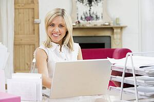 Woman sitting at her desk using laptop