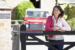 Farmer's Wife Looking Over Farm Gate