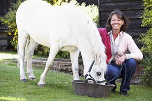 Farmer's Wife Feeding Pony