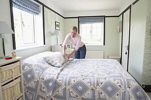 Woman Making Bed