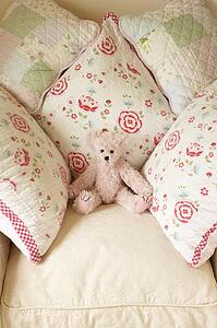 Cushions On Chair With Teddy Bear