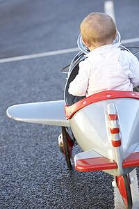 Baby Girl Riding In Toy Aeroplane