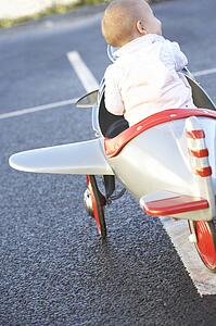 Baby Girl Riding In Toy Aeroplane