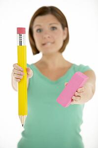 Woman Holding Big Pencil And Eraser