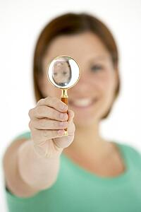 Woman Holding Magnifying Glass