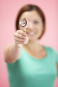 Woman Holding Magnifying Glass