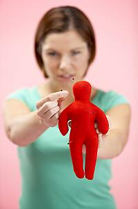 Woman Holding Voodoo Doll